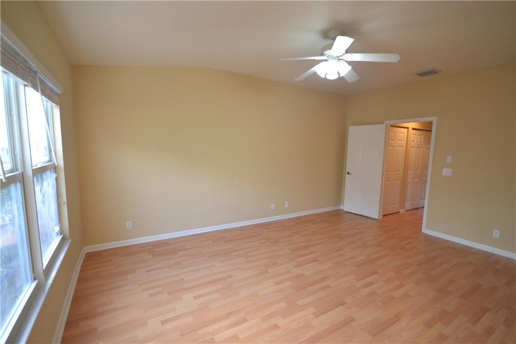 2809 Frederick Boulevard Delray Beach, FL 33483 - Photo 16 of 18 an empty room with a chandelier fan and windows