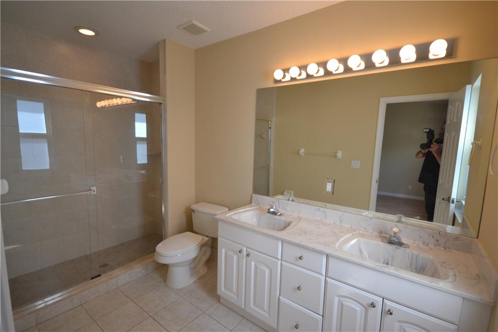2809 Frederick Boulevard Delray Beach, FL 33483 - Photo 17 of 18 a bathroom with a double vanity sink mirror and toilet