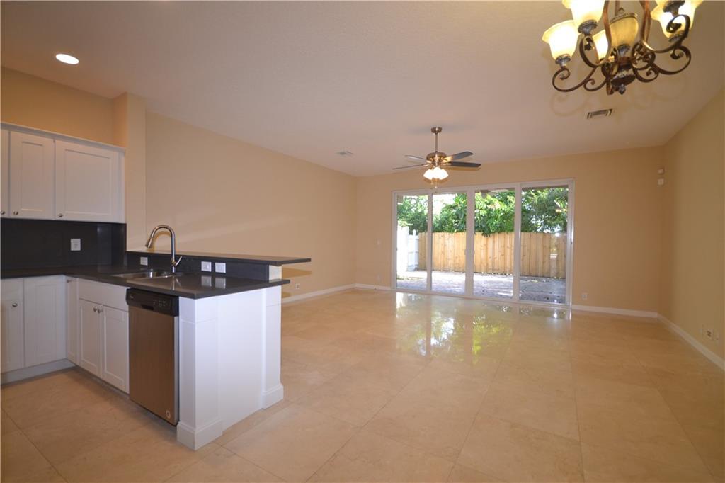 2809 Frederick Boulevard Delray Beach, FL 33483 - Photo 5 of 18 a kitchen with a stove a sink and a window