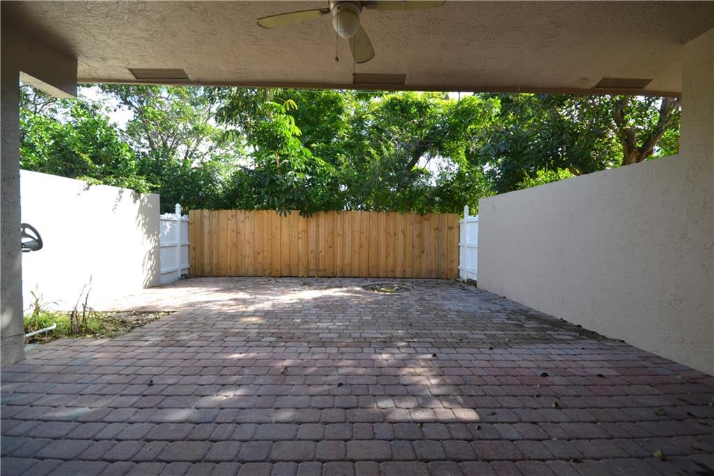 2809 Frederick Boulevard Delray Beach, FL 33483 - Photo 8 of 18 a view of a backyard with plants and a large tree