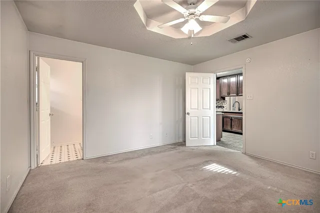 a view of kitchen with sink and refrigerator