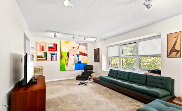 a living room with furniture window and flat screen tv
