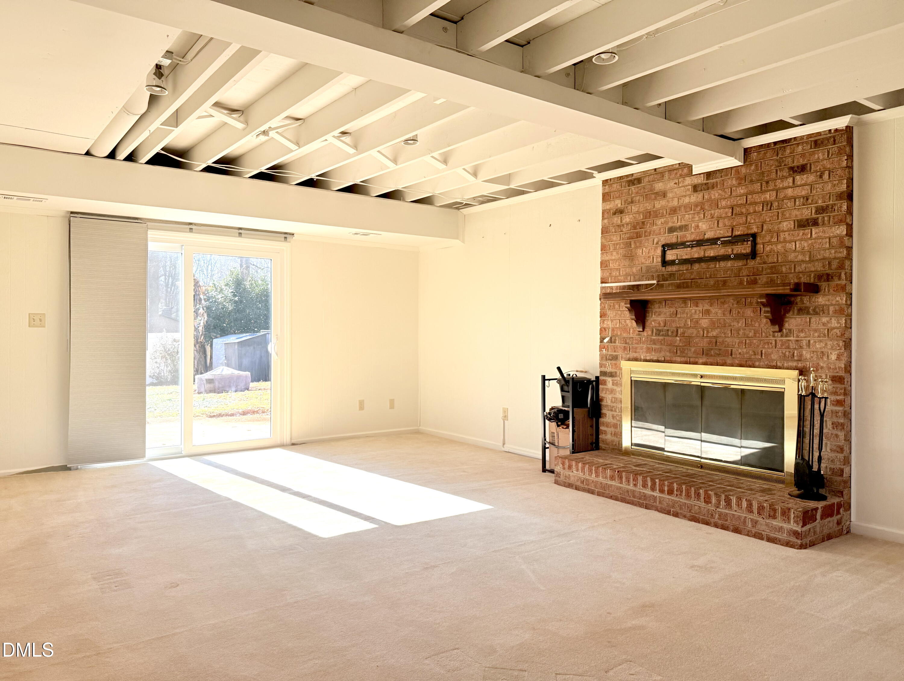 702 Delmar Road Cary, NC 27511 - Photo 12 of 23 a view of empty room with a fireplace and window