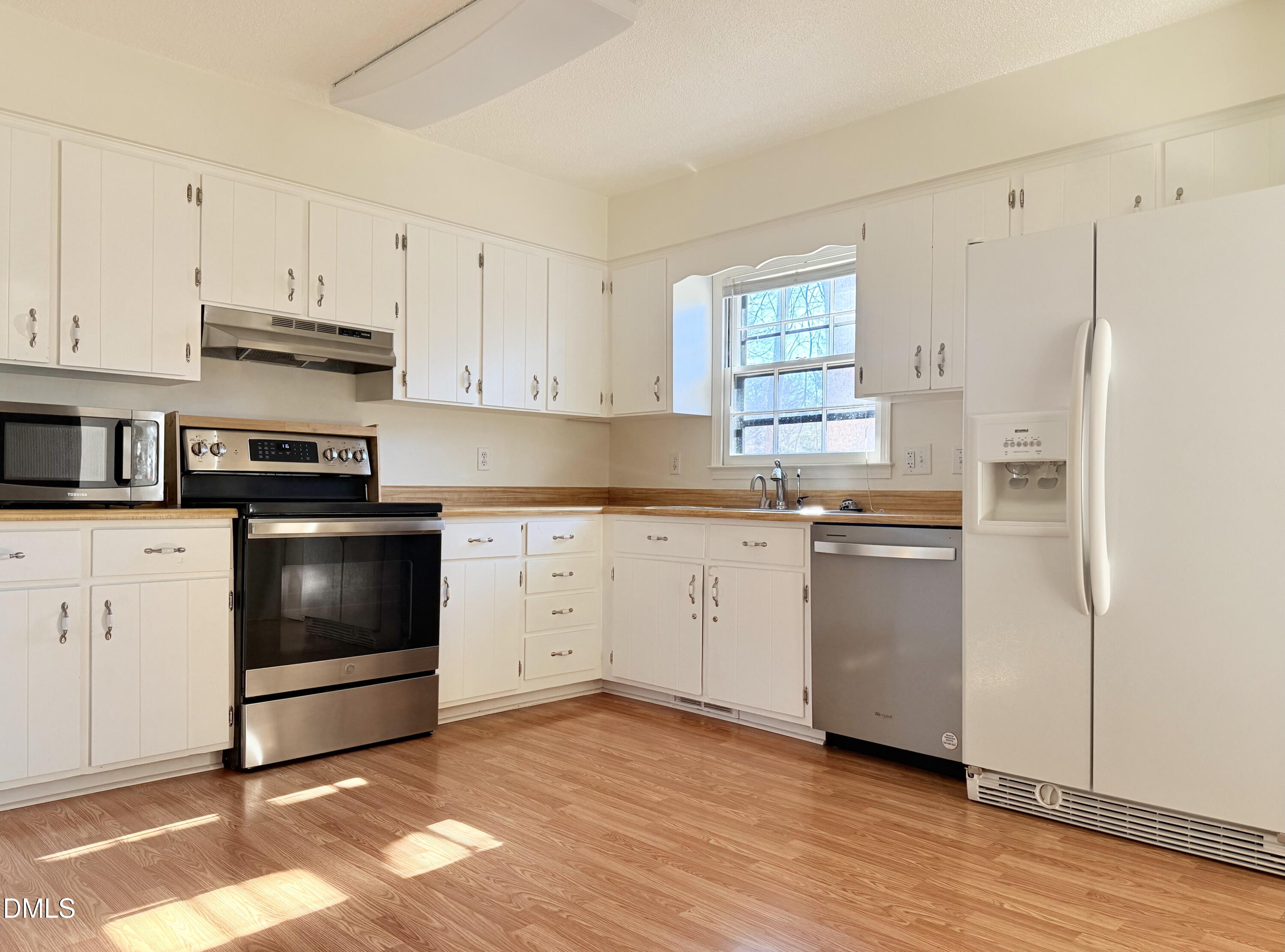 702 Delmar Road Cary, NC 27511 - Photo 13 of 23 a kitchen with granite countertop white cabinets and white appliances