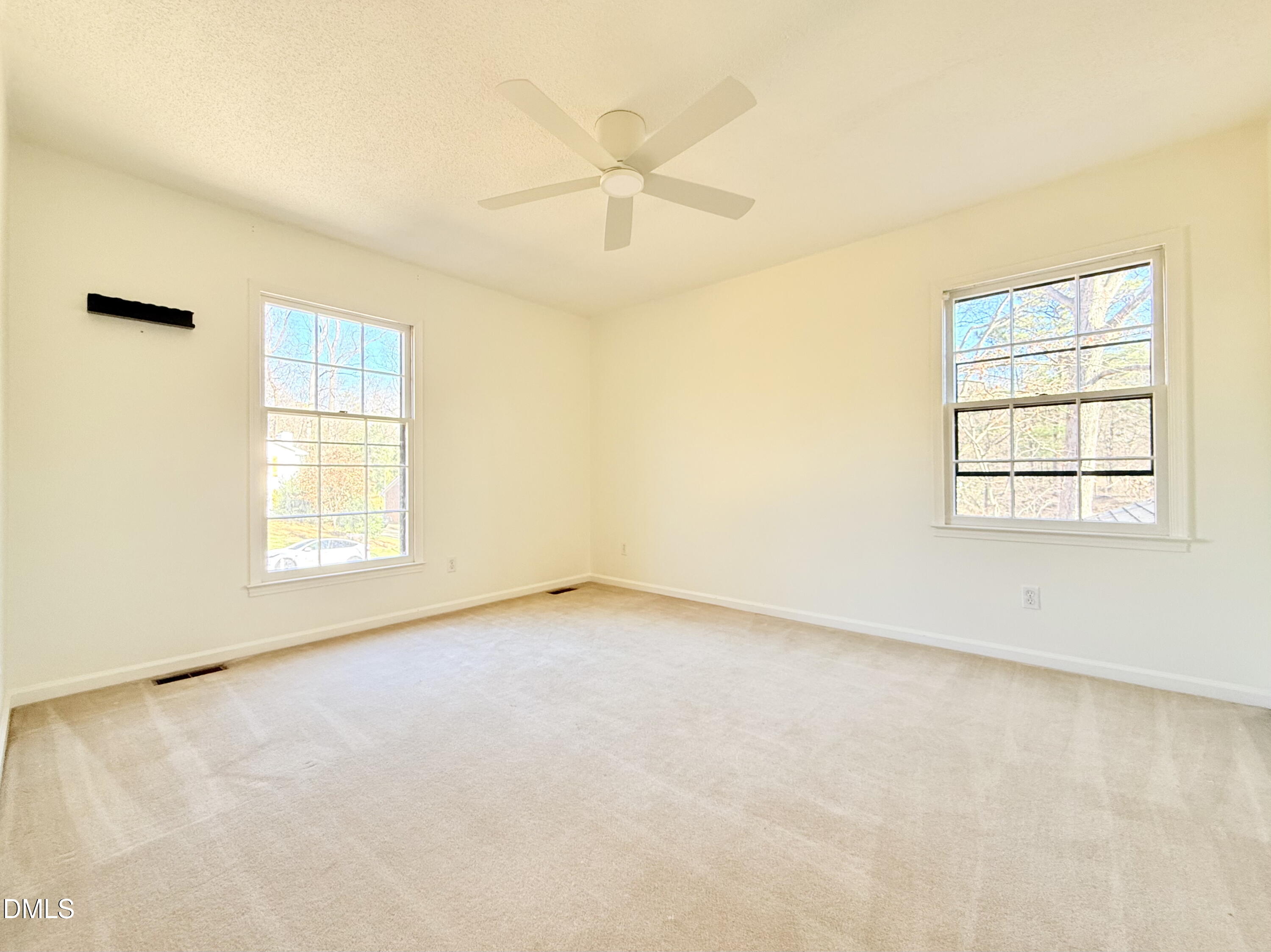 702 Delmar Road Cary, NC 27511 - Photo 17 of 23 an empty room with a window and a fan