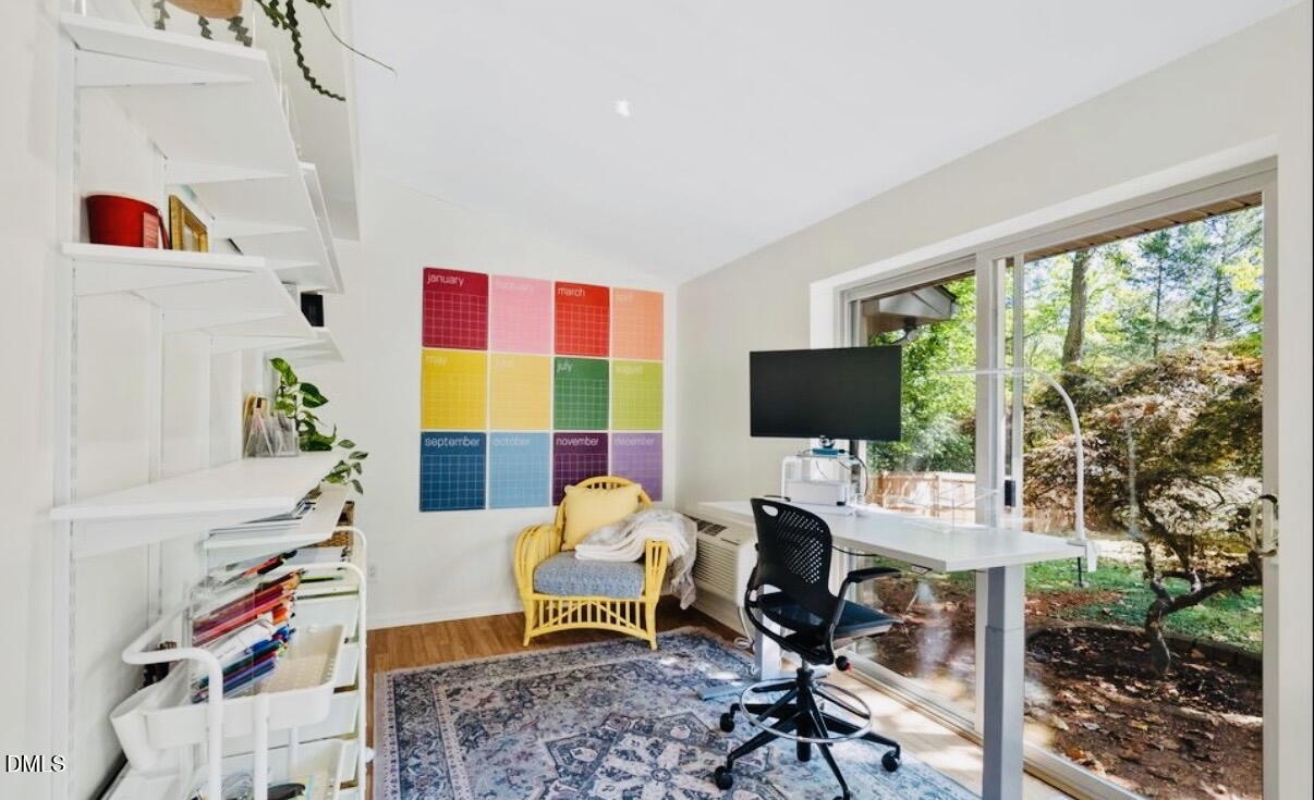702 Delmar Road Cary, NC 27511 - Photo 5 of 23 a living room with furniture a flat screen tv and a floor to ceiling window