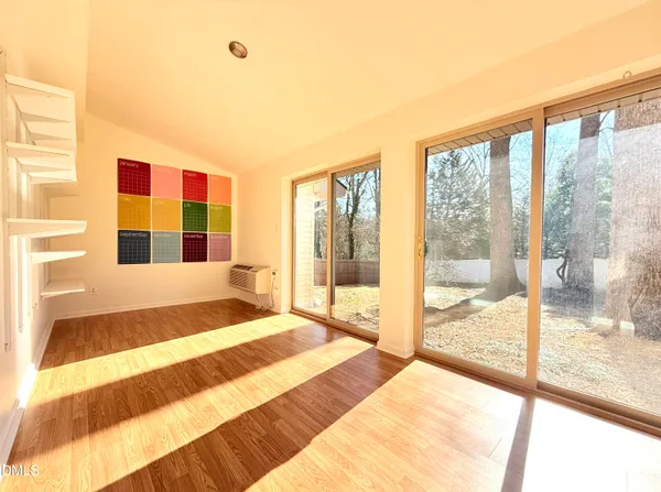 a bedroom with a bed and glass door