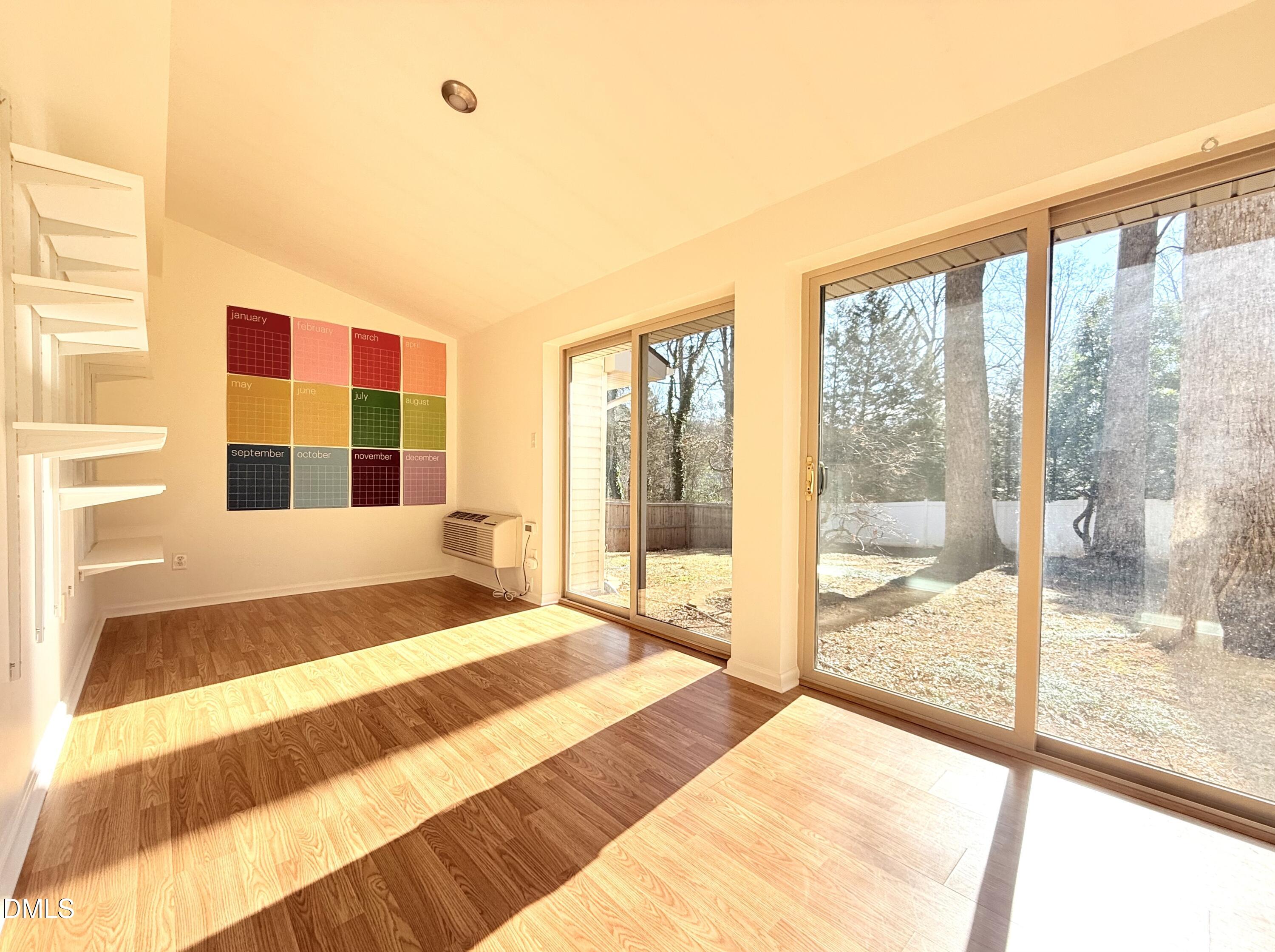 702 Delmar Road Cary, NC 27511 - Photo 8 of 23 a bedroom with a bed and glass door