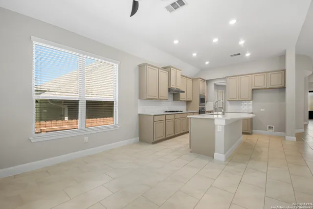 a spacious bedroom with a bed and large window