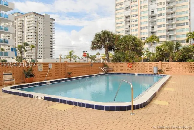 a view of a swimming pool with a lawn chairs