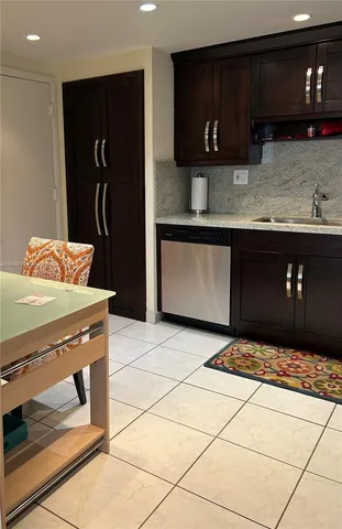 a kitchen with stainless steel appliances granite countertop a stove a refrigerator and a sink