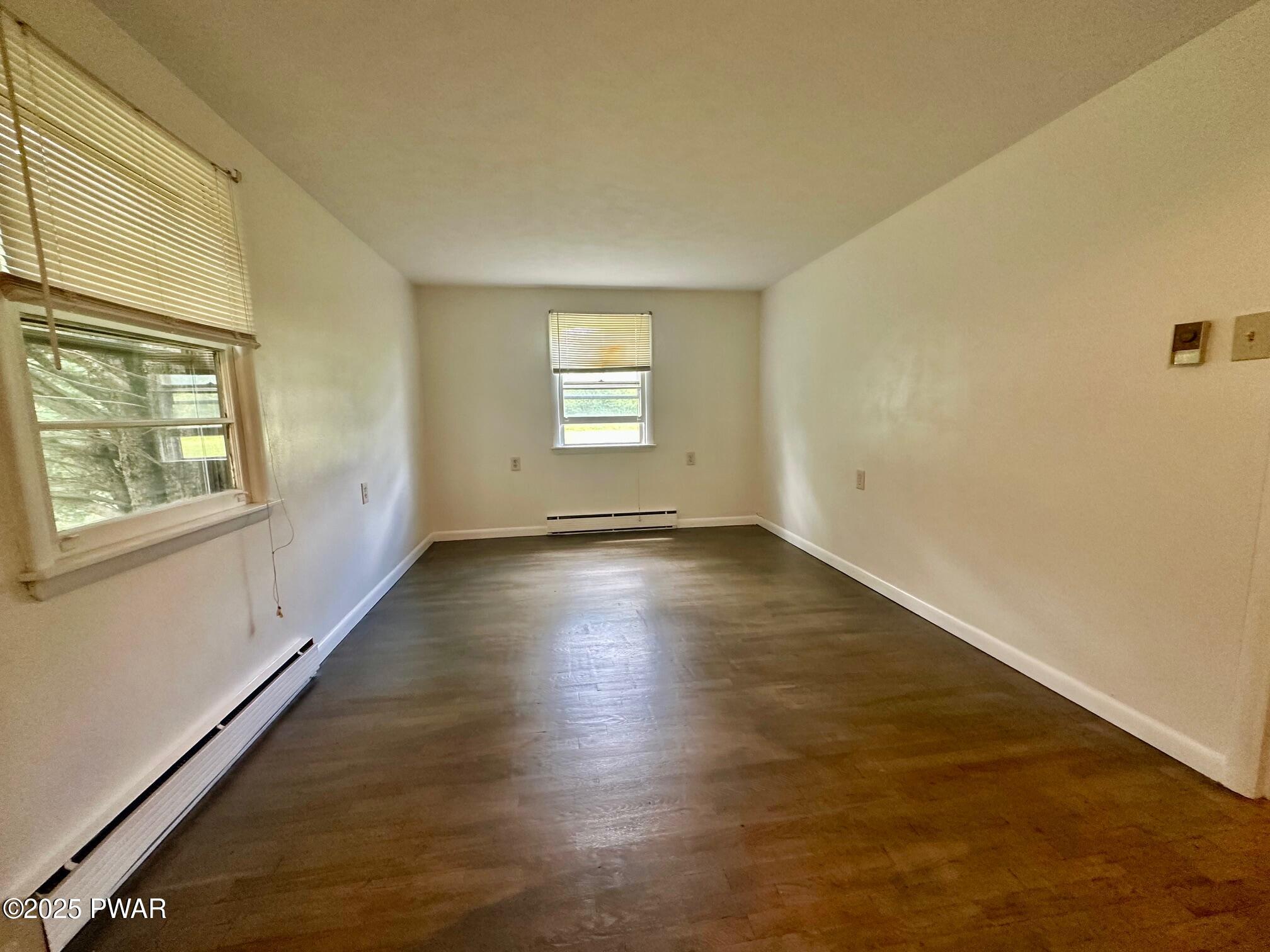 191 Hemlock Grove Road Greentown, PA 18426 - Photo 27 of 31 an empty room with wooden floor and windows