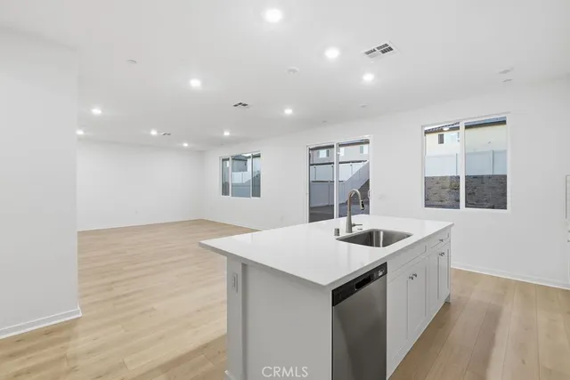 a kitchen with a sink and natural light