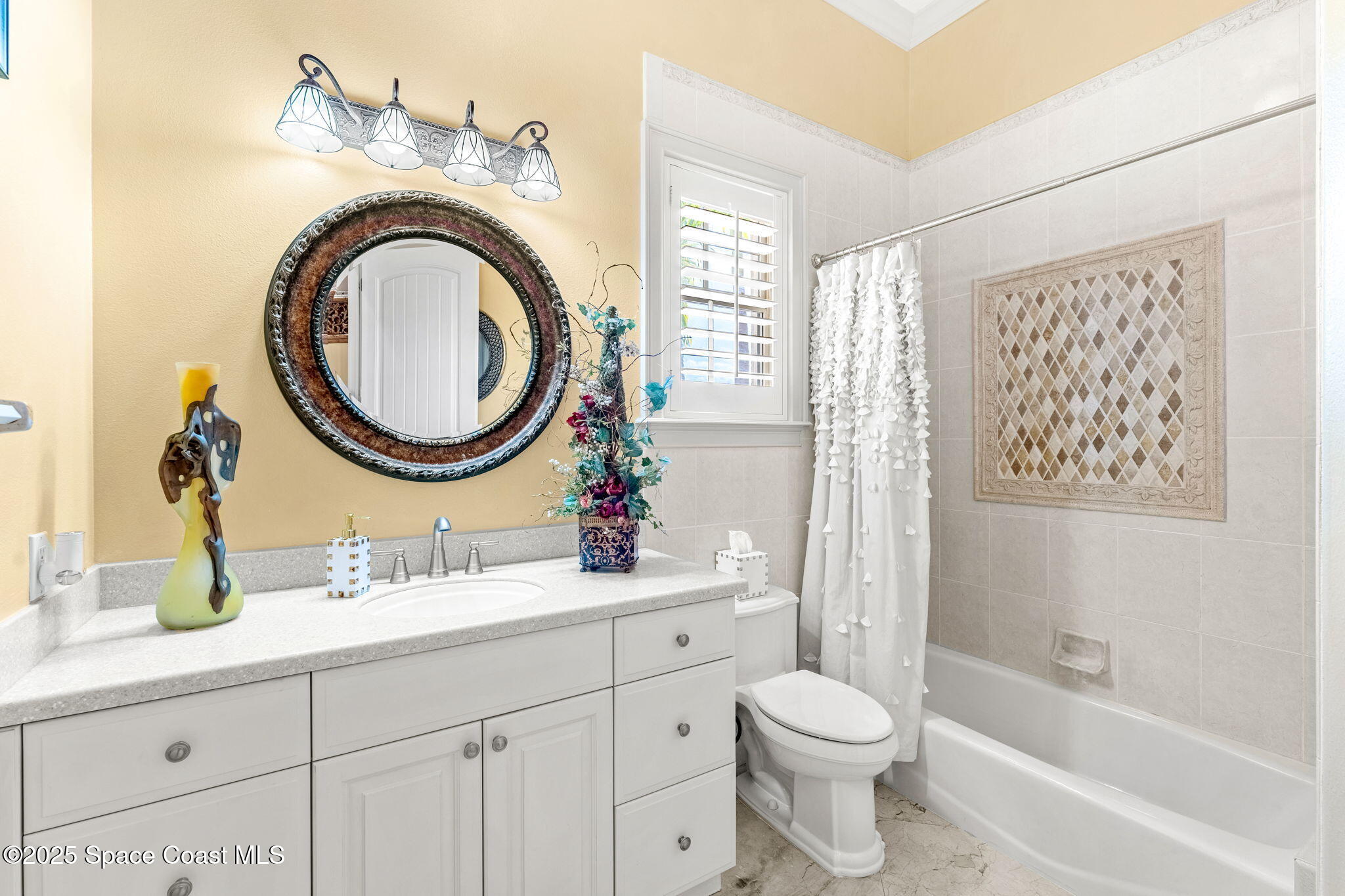 3738 Cappio Drive Melbourne, FL 32940 - Photo 29 of 62 a bathroom with a sink a mirror a toilet and a bathtub
