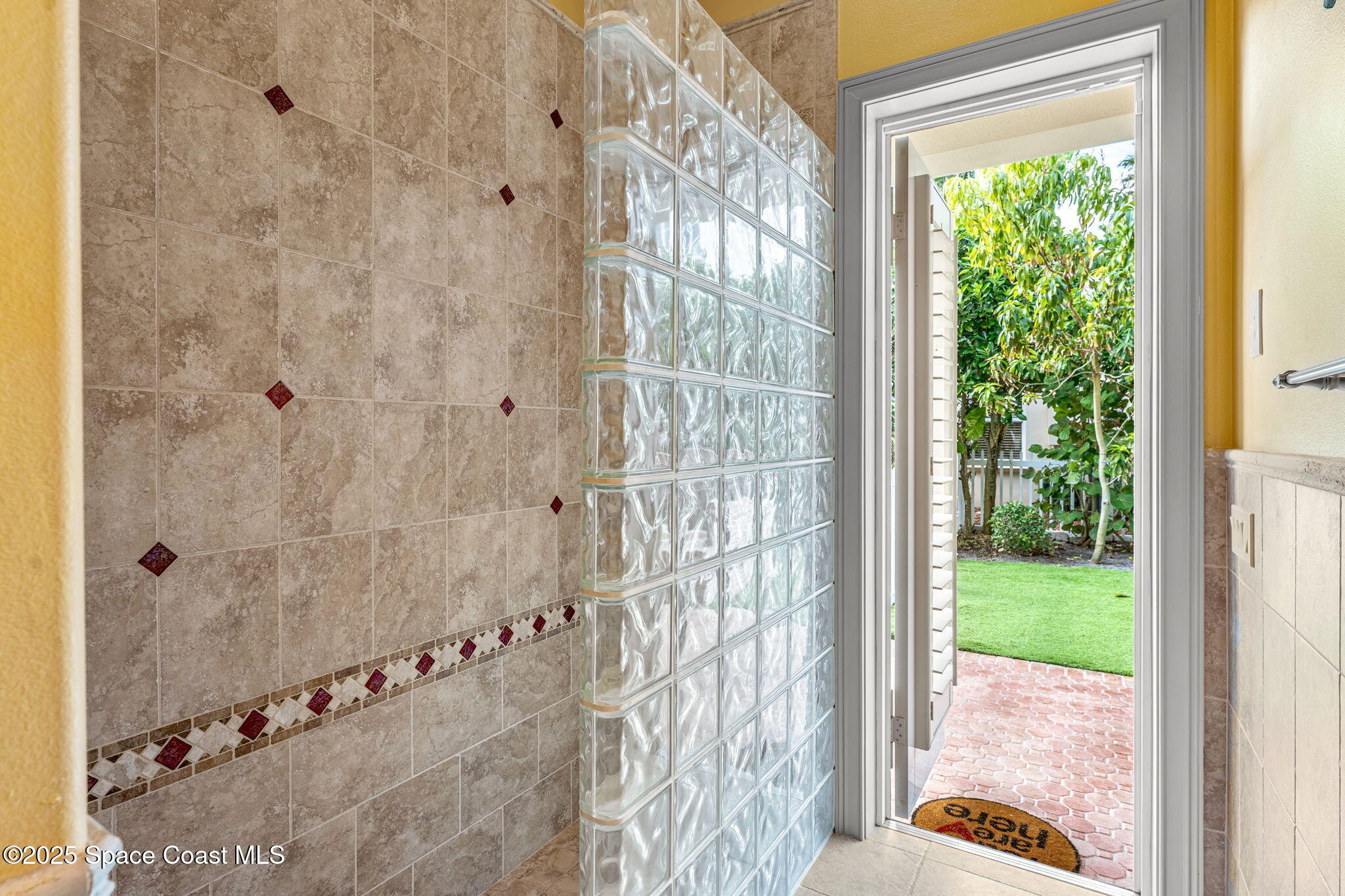 3738 Cappio Drive Melbourne, FL 32940 - Photo 33 of 62 a bathroom with a glass door shower
