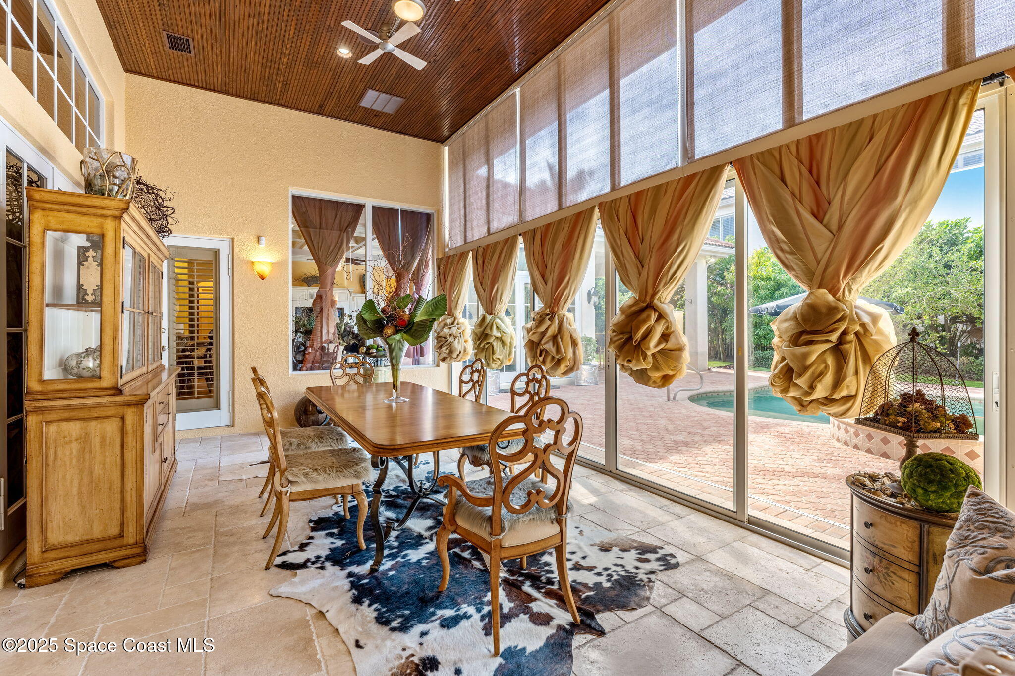 3738 Cappio Drive Melbourne, FL 32940 - Photo 34 of 62 a dining room with furniture and large windows