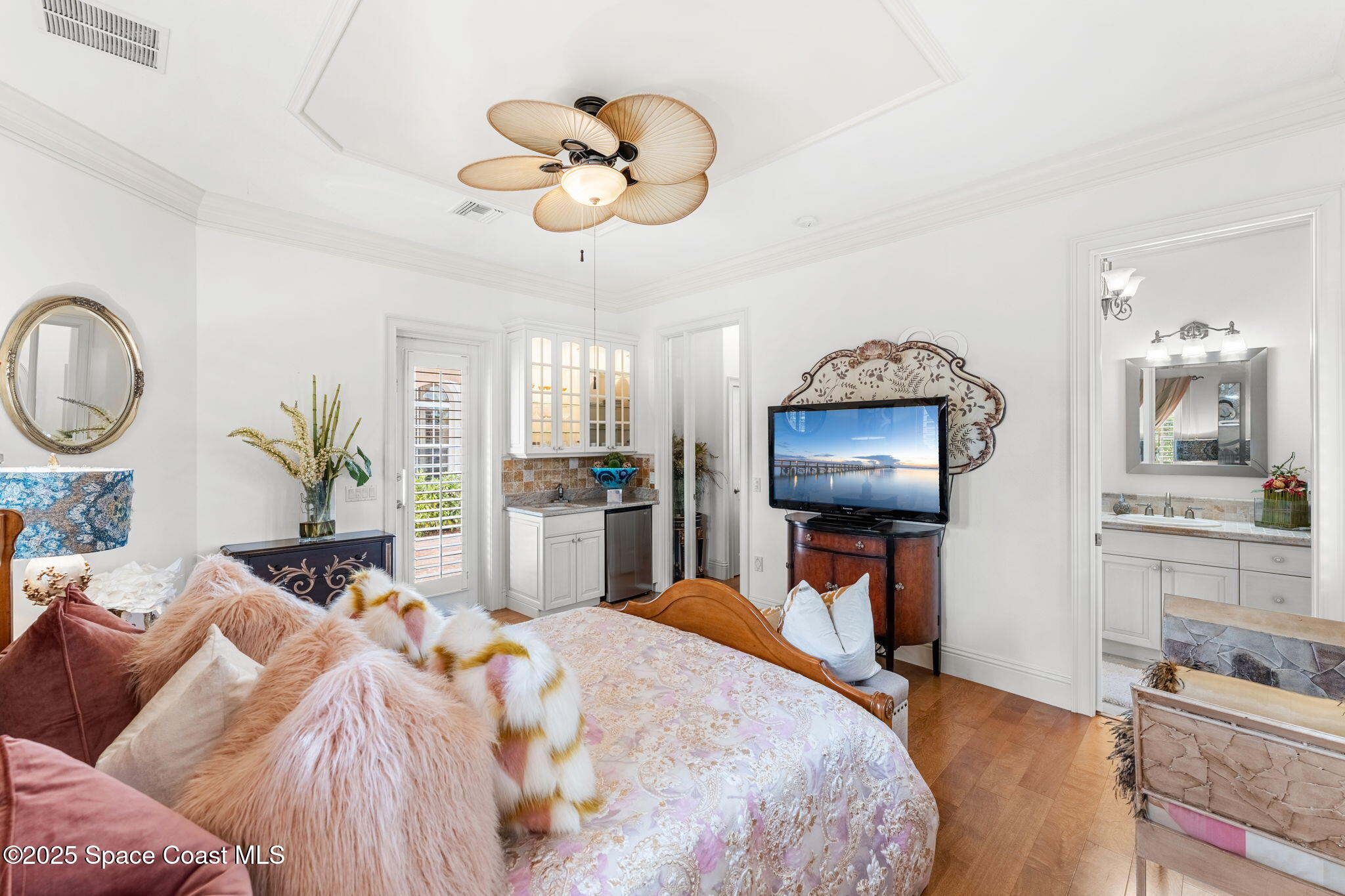 3738 Cappio Drive Melbourne, FL 32940 - Photo 40 of 62 a bedroom with bed and a chandelier