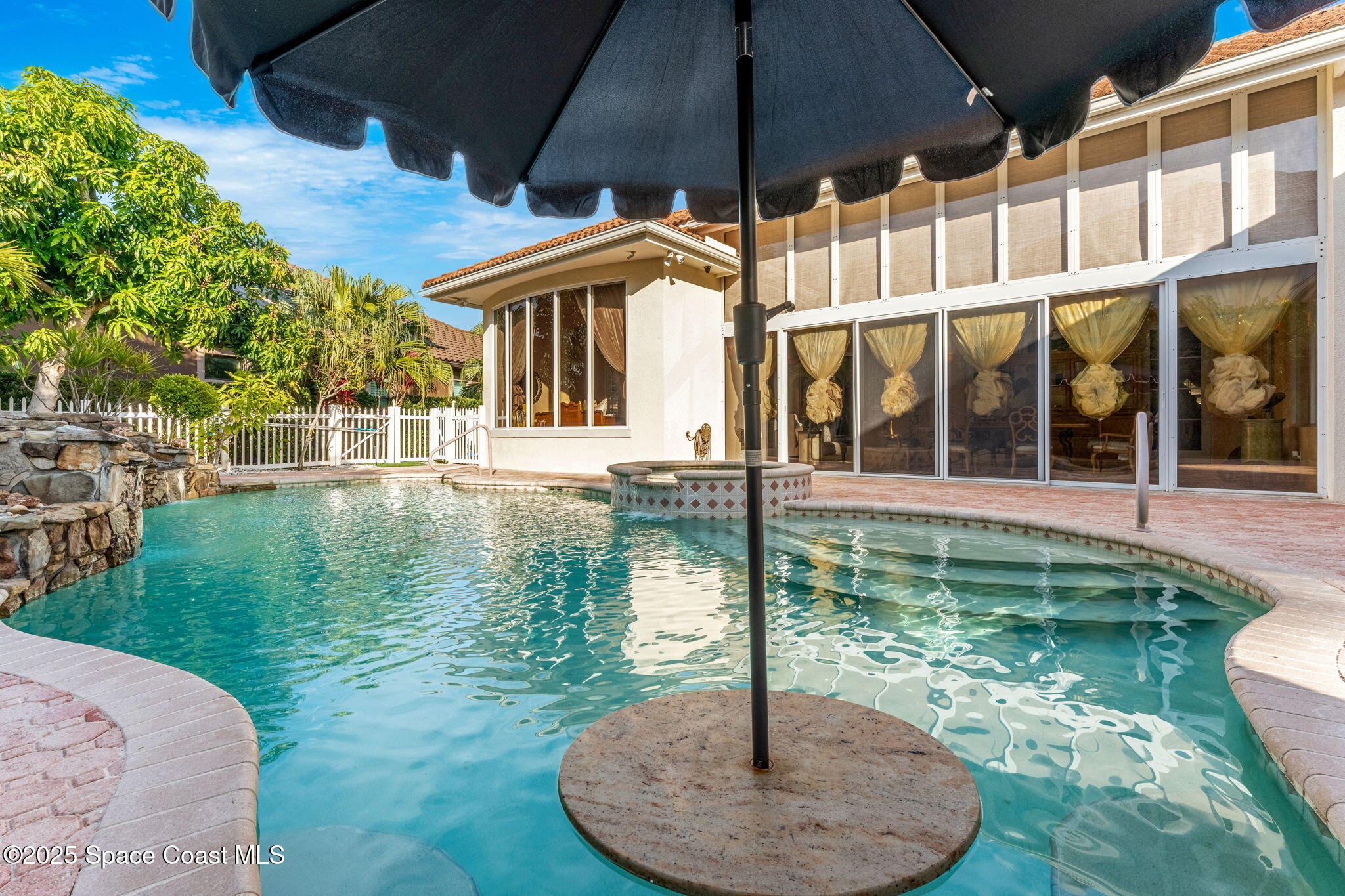 3738 Cappio Drive Melbourne, FL 32940 - Photo 45 of 62 a backyard of a house with yard table and chairs