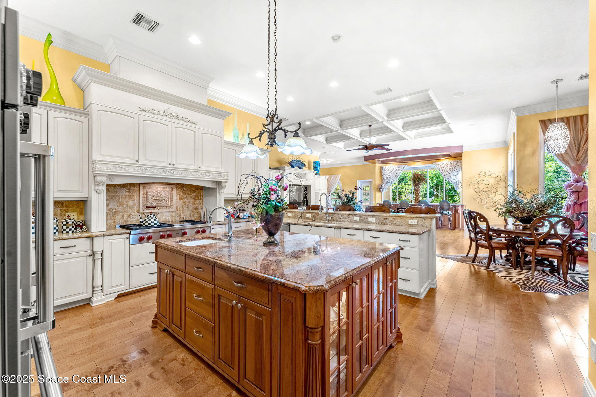 3738 Cappio Drive Melbourne, FL 32940 - Photo 9 of 62 a kitchen with stainless steel appliances granite countertop a stove a sink dishwasher and a dining table with wooden floor