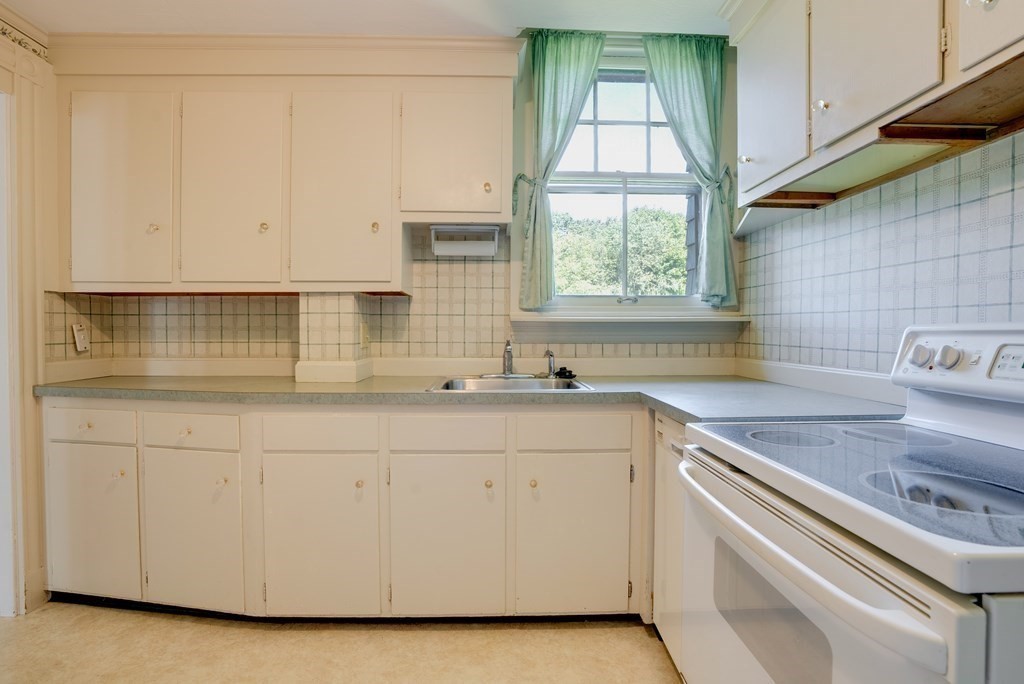156 Chestnut Street, Unit 6 North Andover, MA 01845 - Photo 12 of 27 a kitchen with granite countertop white cabinets and a sink