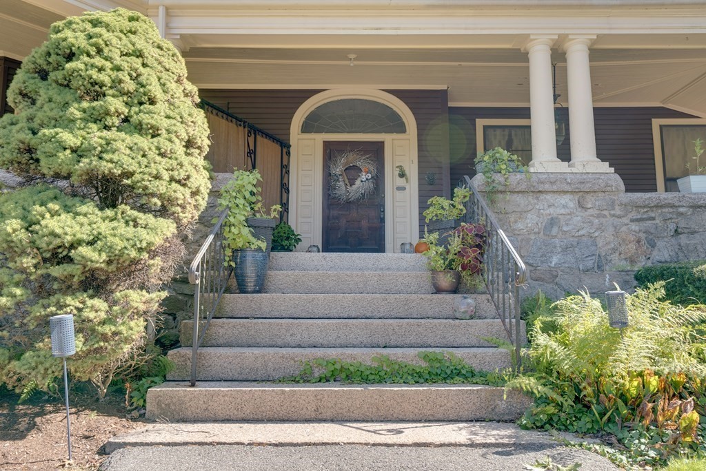 156 Chestnut Street, Unit 6 North Andover, MA 01845 - Photo 2 of 27 a front view of a house with a garden