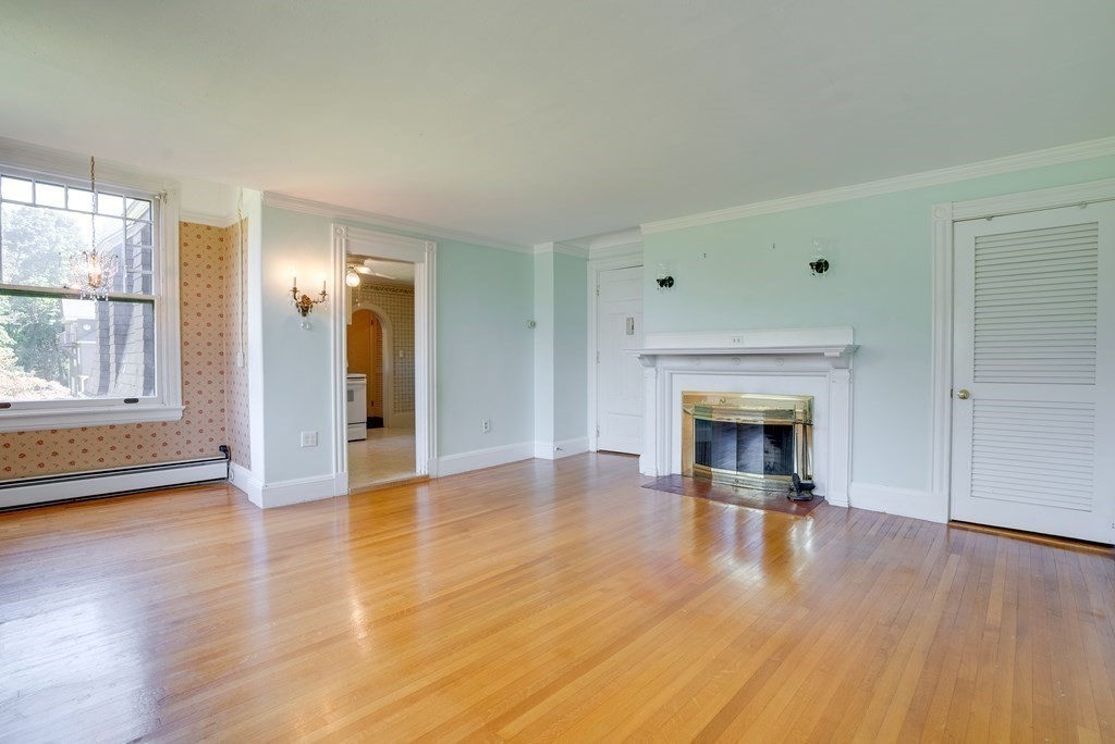 156 Chestnut Street, Unit 6 North Andover, MA 01845 - Photo 3 of 27 a view of a livingroom with wooden floor a fireplace and window