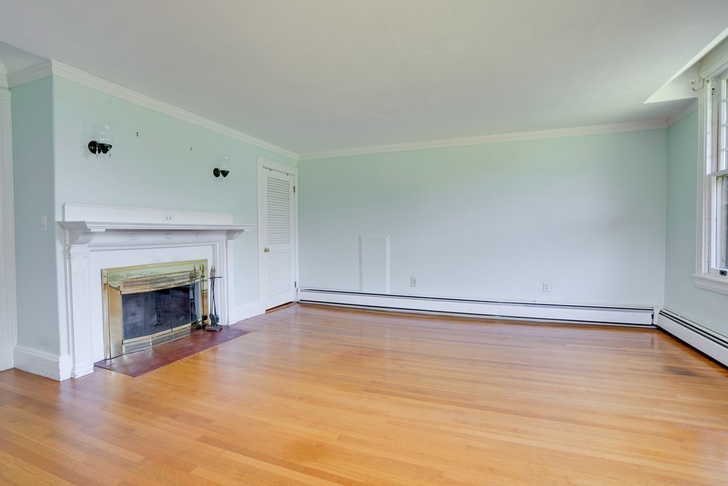 156 Chestnut Street, Unit 6 North Andover, MA 01845 - Photo 5 of 27 a view of an empty room with wooden floor and a window