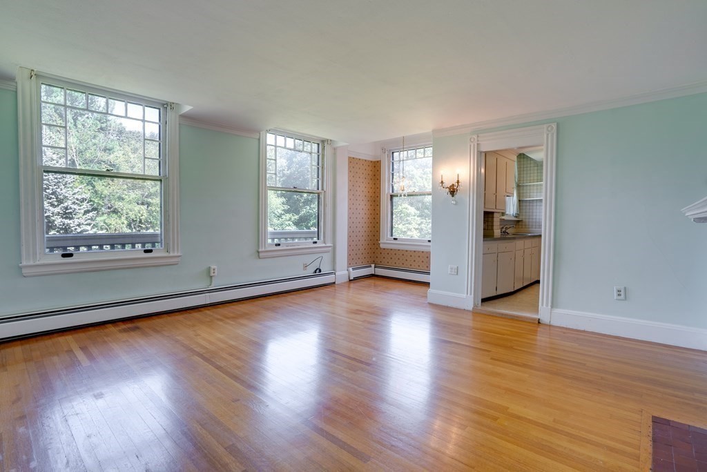 156 Chestnut Street, Unit 6 North Andover, MA 01845 - Photo 7 of 27 an empty room with wooden floor and windows