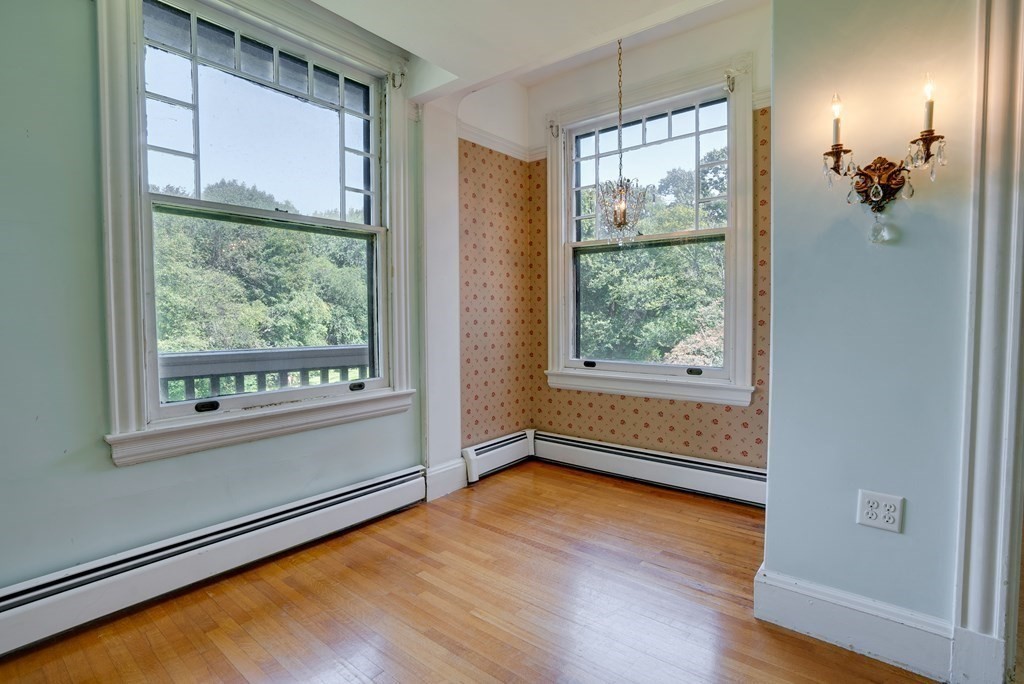 156 Chestnut Street, Unit 6 North Andover, MA 01845 - Photo 8 of 27 an empty room with wooden floor and windows