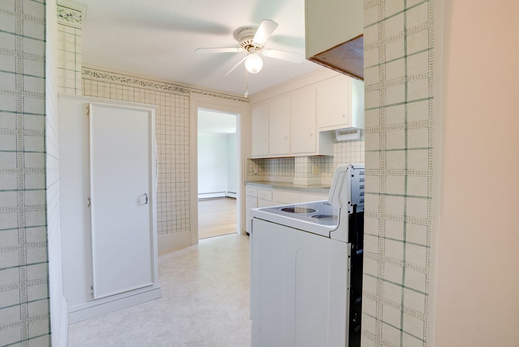 156 Chestnut Street, Unit 6 North Andover, MA 01845 - Photo 10 of 27 a kitchen with a stove a refrigerator and cabinets