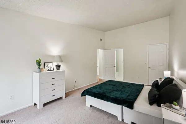 a bathroom with a granite countertop sink toilet a mirror and shower