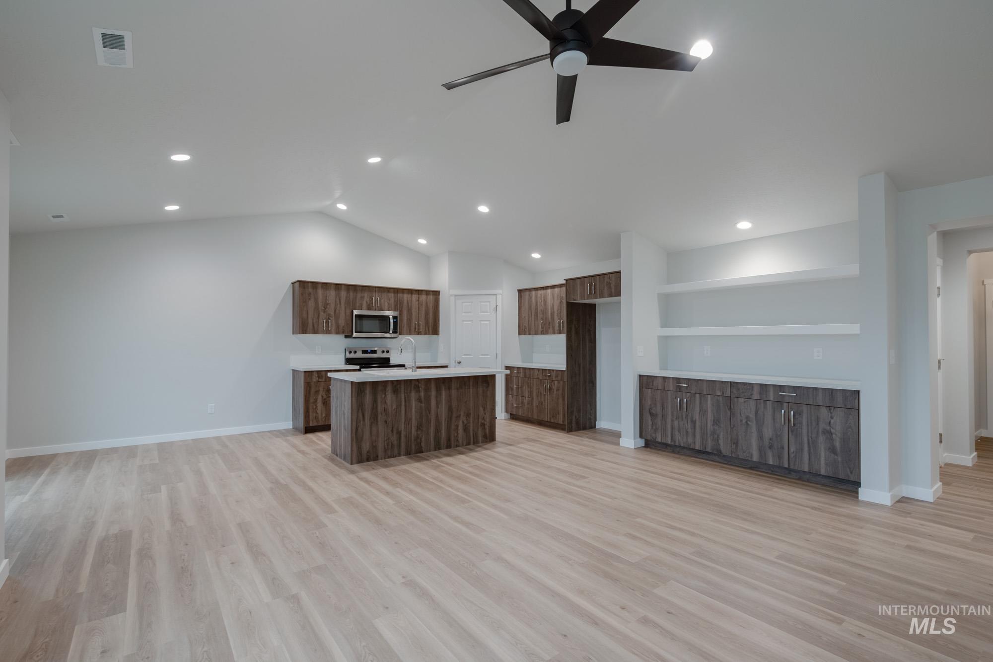 16730 Dunning Way Caldwell, ID 83607 - Photo 22 of 22 Kitchen featuring open floor plan, light countertops, a center island with sink, light wood-type flooring, and recessed lighting