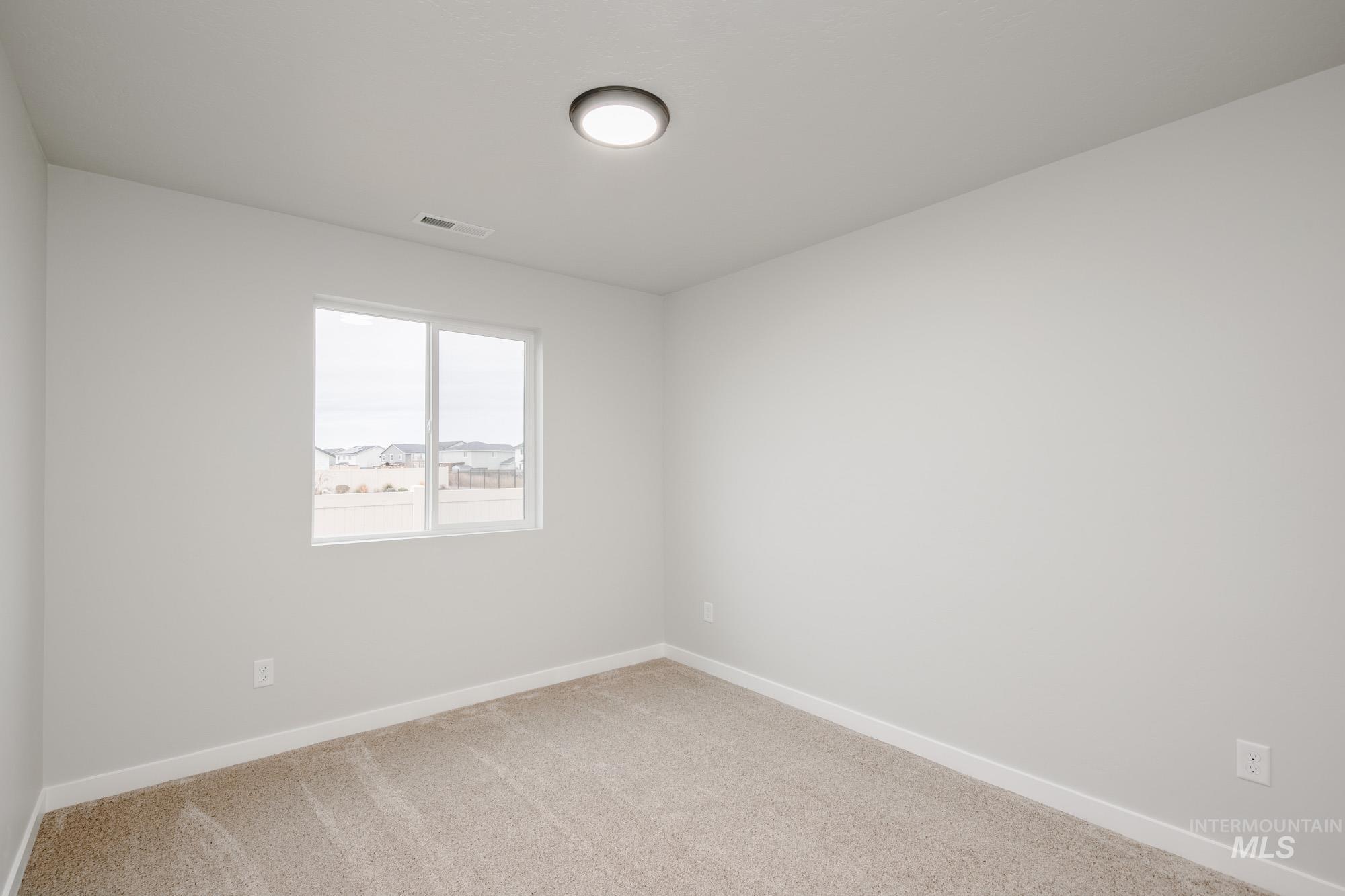 16730 Dunning Way Caldwell, ID 83607 - Photo 11 of 22 Carpeted spare room with baseboards