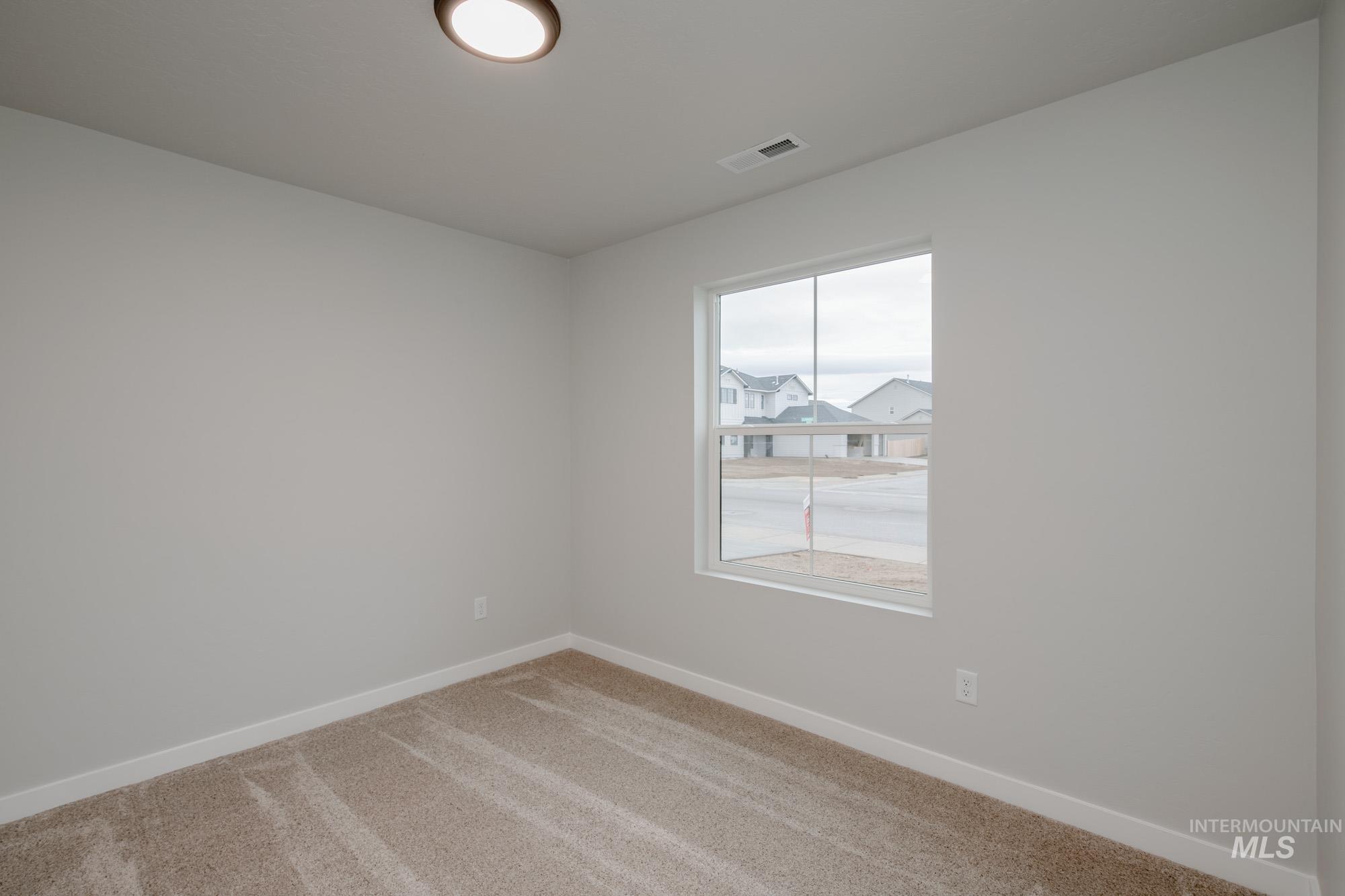 16730 Dunning Way Caldwell, ID 83607 - Photo 12 of 22 Carpeted empty room featuring baseboards