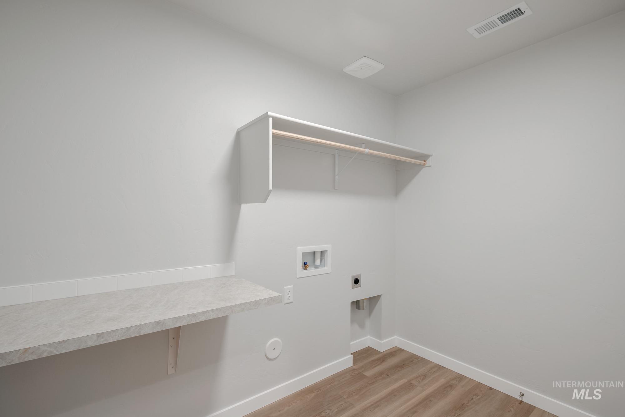 16730 Dunning Way Caldwell, ID 83607 - Photo 15 of 22 Laundry area featuring light wood-type flooring, washer hookup, and electric dryer hookup
