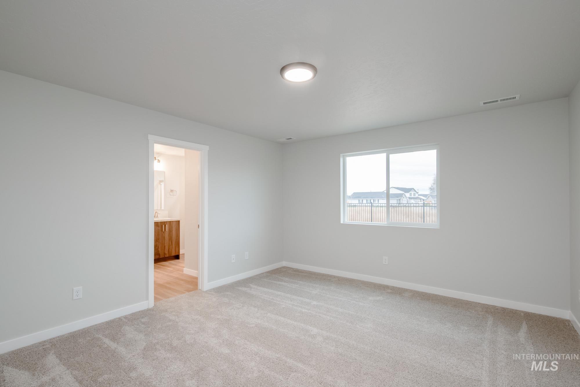16730 Dunning Way Caldwell, ID 83607 - Photo 16 of 22 Spare room featuring light colored carpet and baseboards