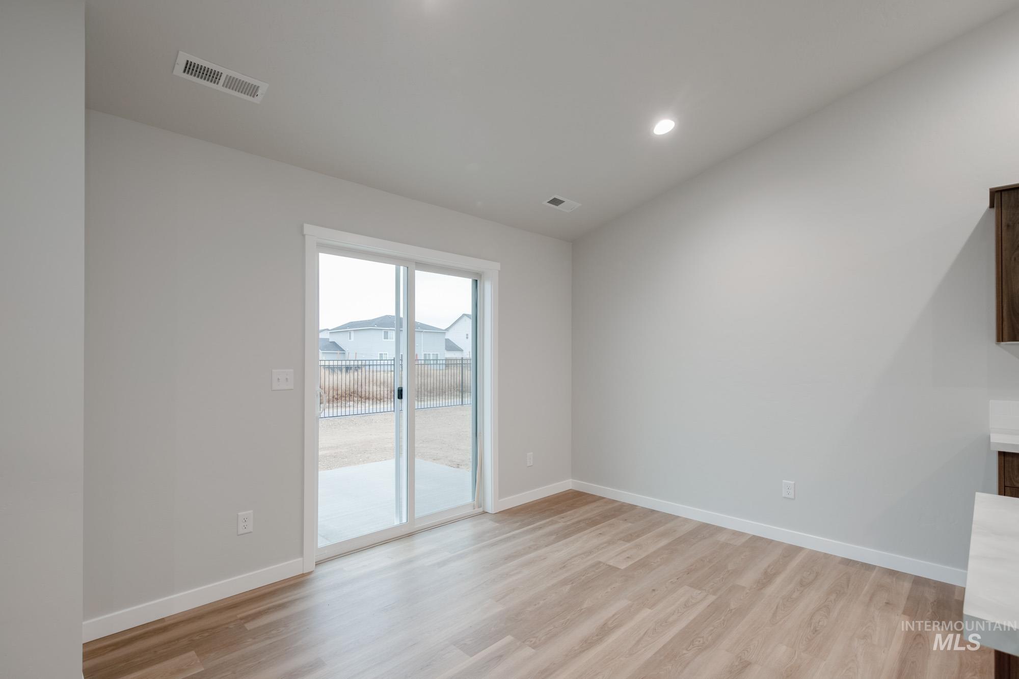 16730 Dunning Way Caldwell, ID 83607 - Photo 8 of 22 Unfurnished living room featuring light wood-style flooring and recessed lighting