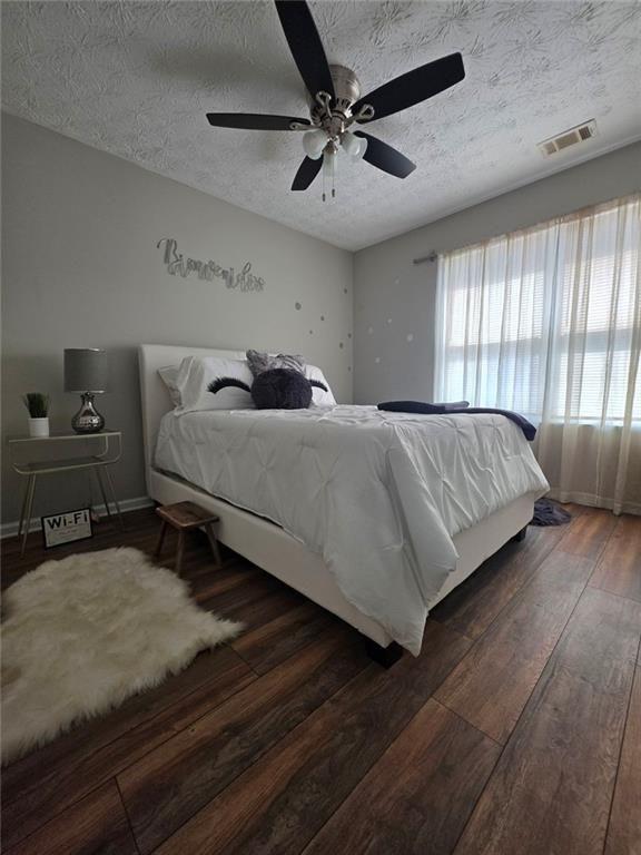 6102 Fairington Ridge Circle Lithonia, GA 30038 - Photo 15 of 22 a bedroom with a bed flat screen tv and a large window