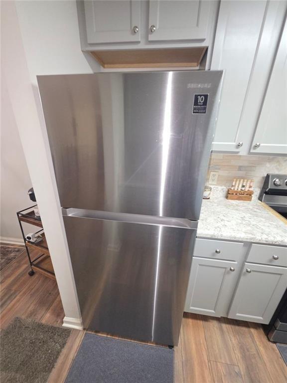 6102 Fairington Ridge Circle Lithonia, GA 30038 - Photo 7 of 22 a view of a refrigerator in kitchen and wooden floor