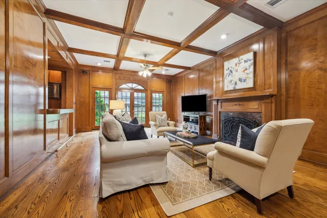 a living room with furniture a large window and a fireplace