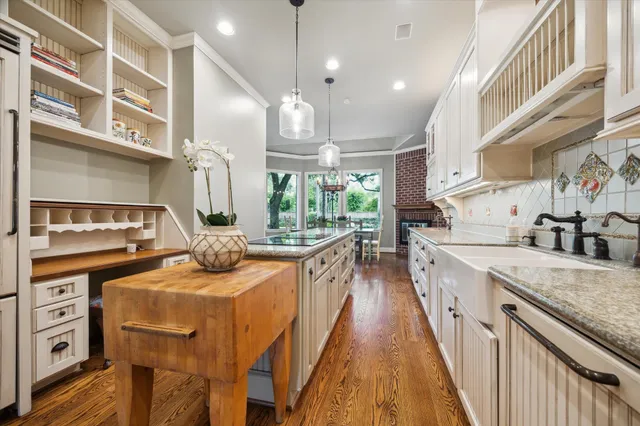 a kitchen with counter top space a sink appliances and cabinets