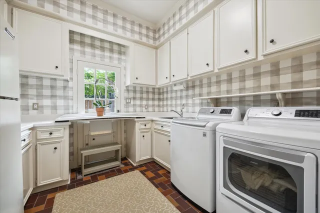 a kitchen with sink cabinets and appliances