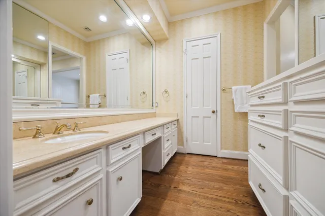 a spacious bathroom with a double vanity sink a mirror and a shower