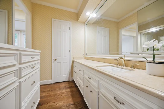 a spacious bathroom with a granite countertop sink and a mirror
