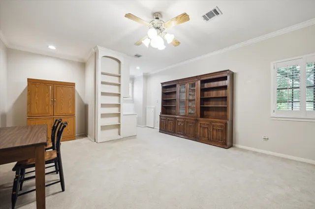 a view of a livingroom with furniture and a ceiling fan