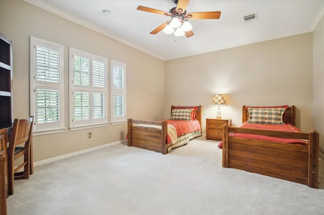 a spacious bedroom with a bed and a chandelier