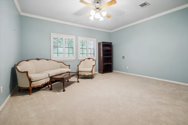 a view of a livingroom with furniture and a ceiling fan