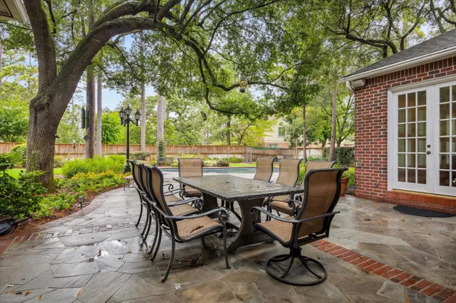 a view of a backyard with table and chairs