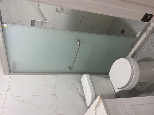 183 Mimosa Road Dale, TX 78616 - Photo 10 of 11 Contemporary bathroom featuring a frosted glass shower enclosure with a stainless steel handle