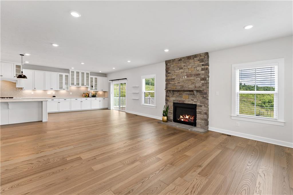 107 Abigail Drive Mars, PA 16046 - Photo 14 of 50 a view of a kitchen with furniture a fireplace and wooden floor